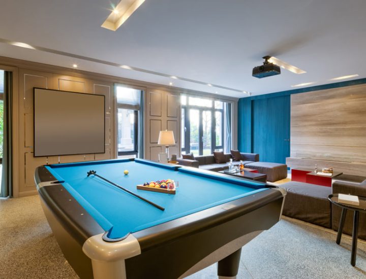 game room with pool table and brown couch
